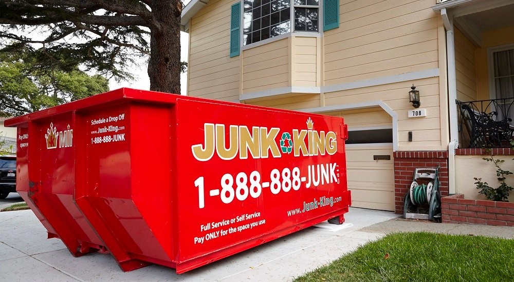 Junk King dumpster in residential driveway